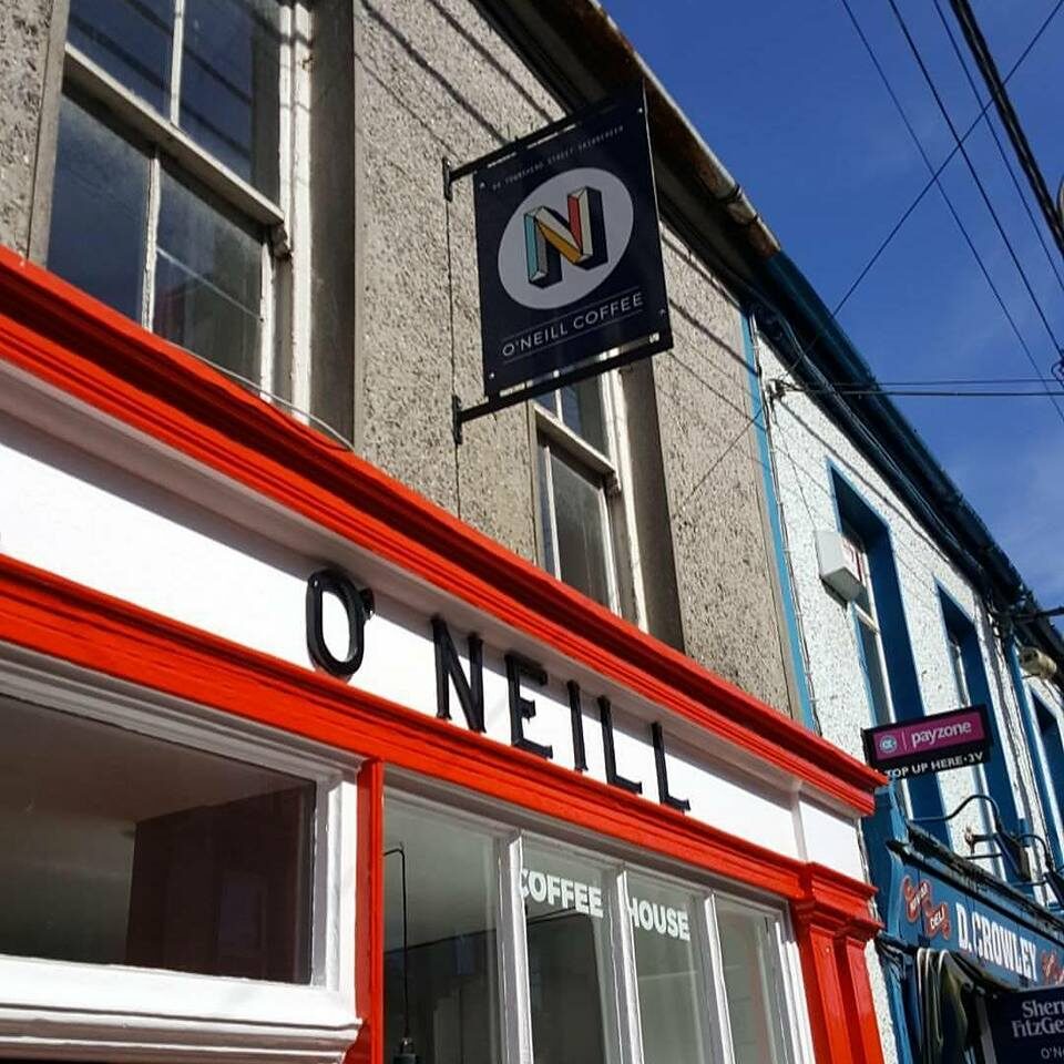 The O'Neill Coffee blade sign and black fascia lettering seen from the street below